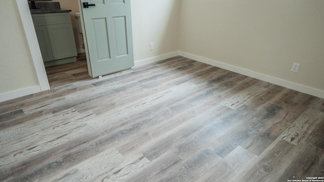 5806 Gillis, San Antonio, TX 78240 - unfurnished bedroom with baseboards and light wood-style flooring