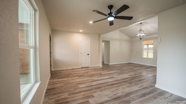 5806 Gillis, San Antonio, TX 78240 - empty room with ceiling fan with notable chandelier, recessed lighting, baseboards, wood finished floors, and vaulted ceiling