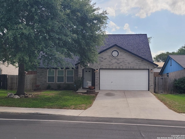 view of front of house with concrete driveway, fence, a front yard, and a garage