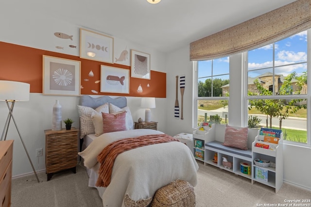 carpeted bedroom featuring baseboards