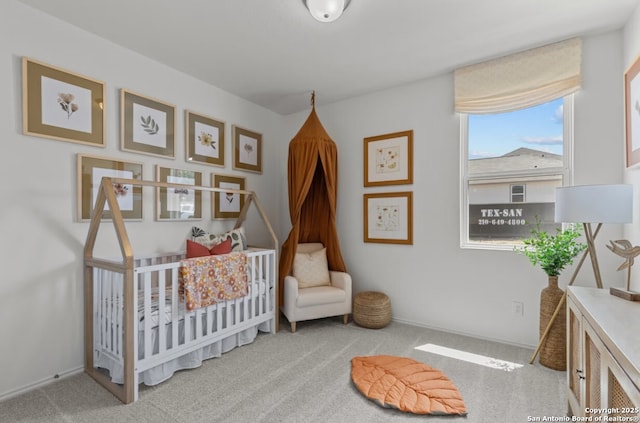 bedroom with carpet floors and a nursery area