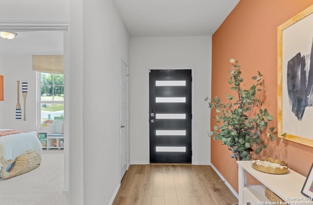 entrance foyer with baseboards and light wood finished floors