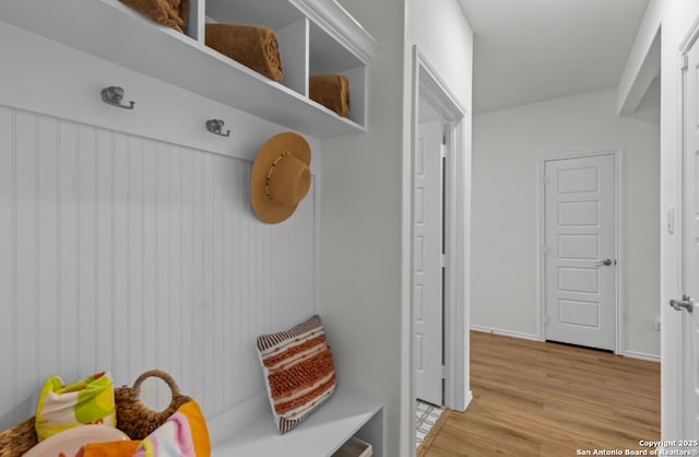 mudroom with baseboards and light wood-style flooring