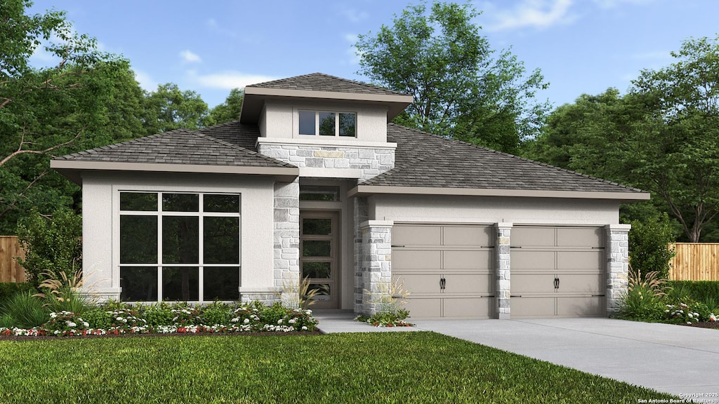 prairie-style house featuring a garage, fence, stone siding, stucco siding, and driveway