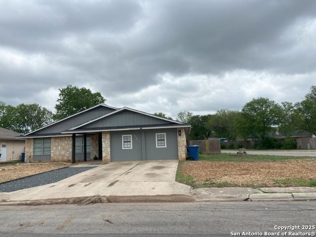 view of front of home with concrete driveway and stone siding