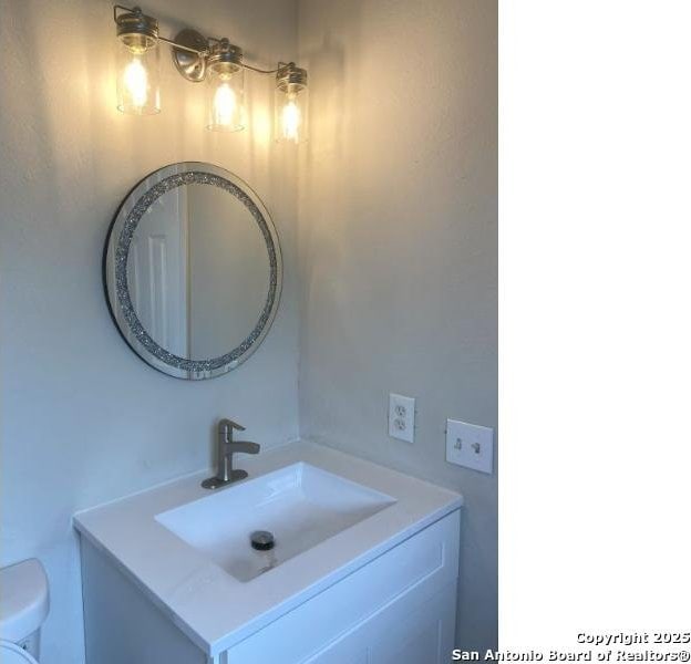 bathroom with vanity and toilet