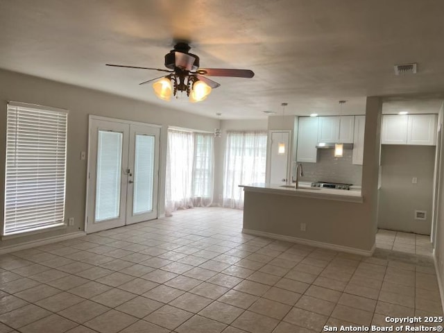 living room featuring french doors, a ceiling fan, visible vents, baseboards, and light tile patterned flooring