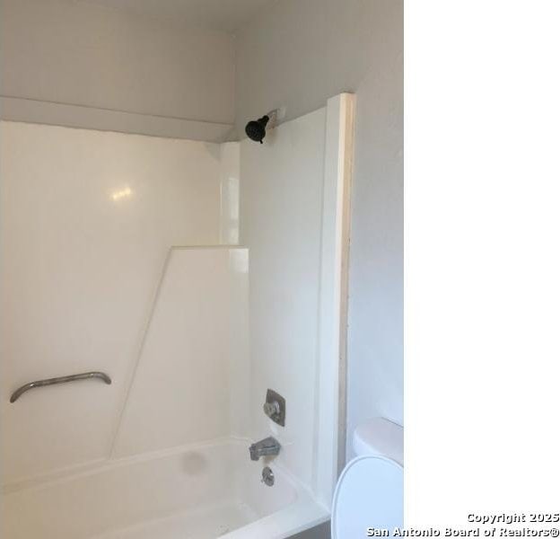 full bath featuring shower / bath combination and toilet