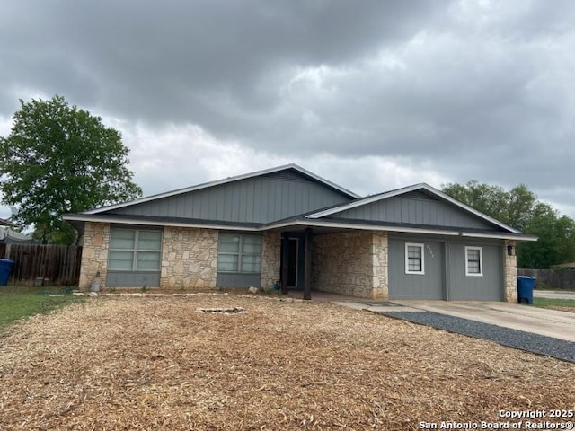 single story home with fence and stone siding