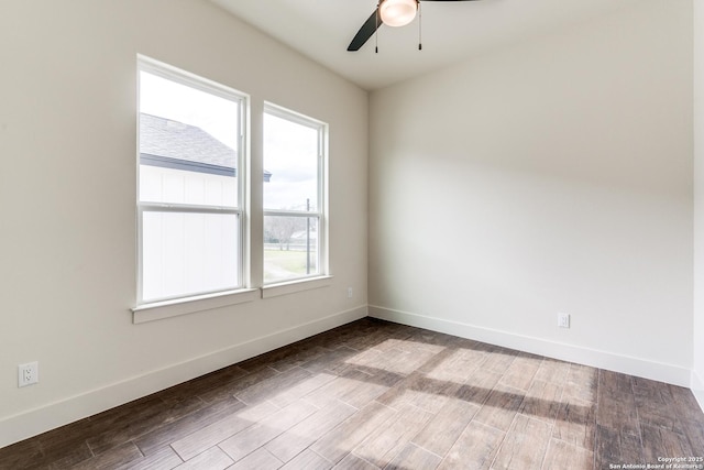 empty room featuring baseboards, ceiling fan, and wood finished floors