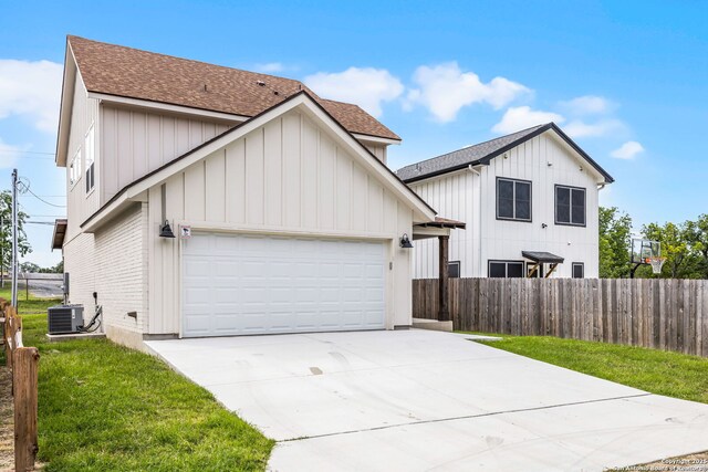 182 Torrey, New Braunfels, TX 78130 - modern farmhouse with roof with shingles, an attached garage, concrete driveway, board and batten siding, and central AC