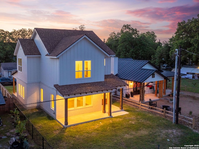 182 Torrey, New Braunfels, TX 78130 - back of house featuring a shingled roof, brick siding, and a patio