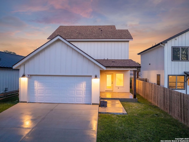 182 Torrey, New Braunfels, TX 78130 - view of front of home featuring a shingled roof, driveway, an attached garage, and board and batten siding