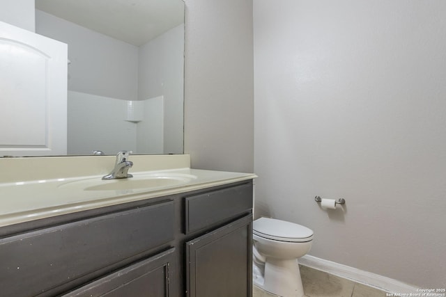 bathroom with toilet, baseboards, tile patterned flooring, and vanity