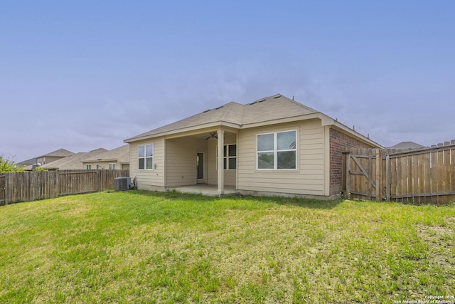 back of house featuring a patio, ceiling fan, central AC unit, and a fenced backyard
