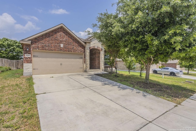 view of front of property with an attached garage, concrete driveway, brick siding, and a front yard