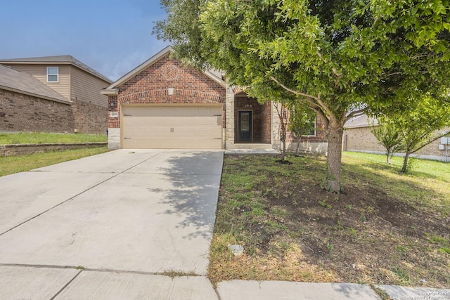 obstructed view of property featuring brick siding, an attached garage, and concrete driveway