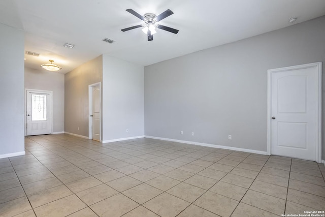 spare room with light tile patterned floors, baseboards, ceiling fan, and visible vents