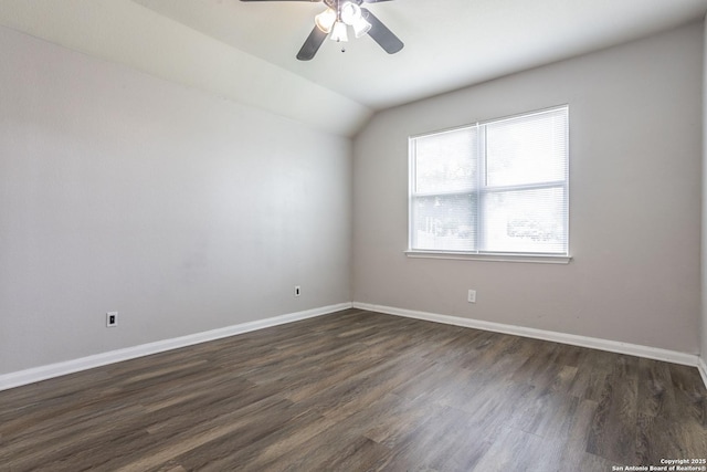 empty room featuring dark wood-style flooring, baseboards, a ceiling fan, and lofted ceiling