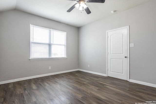 spare room with dark wood-style flooring, ceiling fan, baseboards, and lofted ceiling