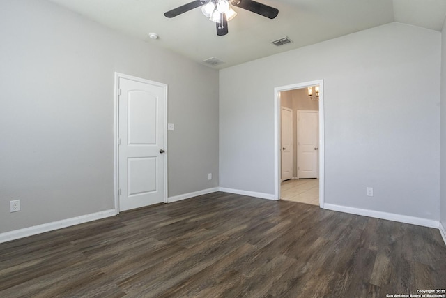 unfurnished room featuring baseboards, ceiling fan, visible vents, and wood finished floors