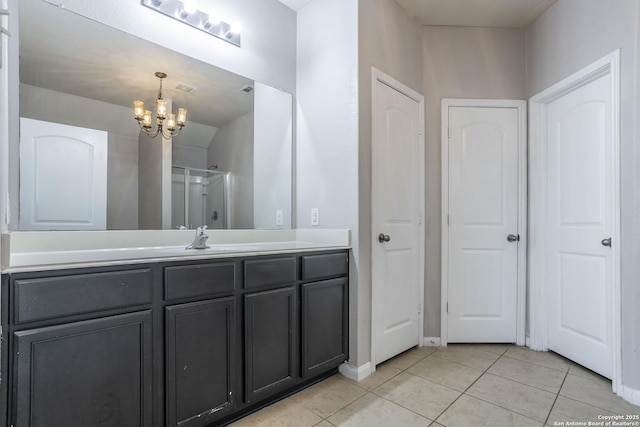 full bathroom with vanity, tile patterned floors, a chandelier, baseboards, and an enclosed shower