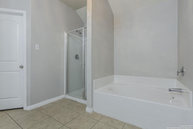 full bathroom with lofted ceiling, baseboards, tile patterned floors, a bath, and a stall shower
