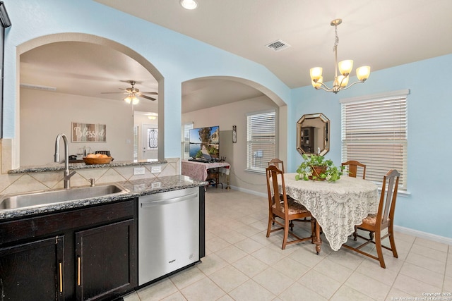 dining area with arched walkways, baseboards, visible vents, and light tile patterned flooring