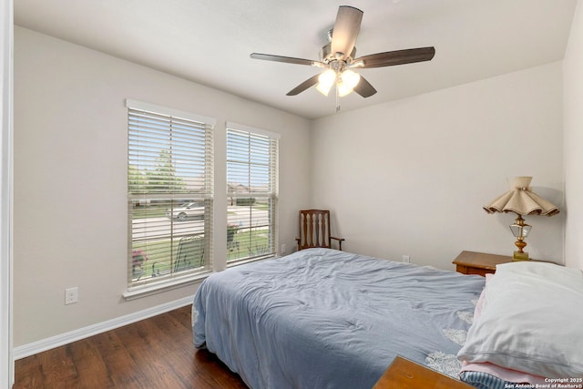 bedroom featuring baseboards, a ceiling fan, and wood finished floors