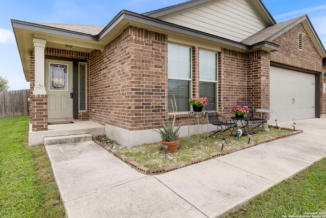 single story home featuring brick siding, an attached garage, fence, and concrete driveway