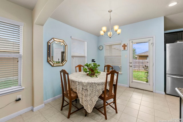 dining area featuring baseboards, a chandelier, and light tile patterned floors