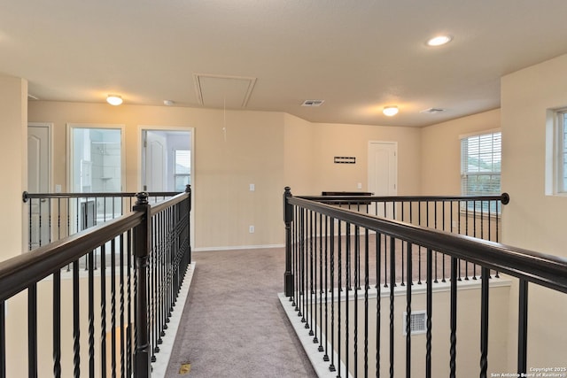 1843 Gray Fox, San Antonio, TX 78245 - corridor with attic access, visible vents, carpet floors, baseboards, and an upstairs landing