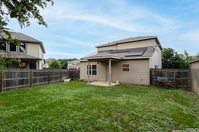 1843 Gray Fox, San Antonio, TX 78245 - back of house with a fenced backyard, a patio, and a lawn