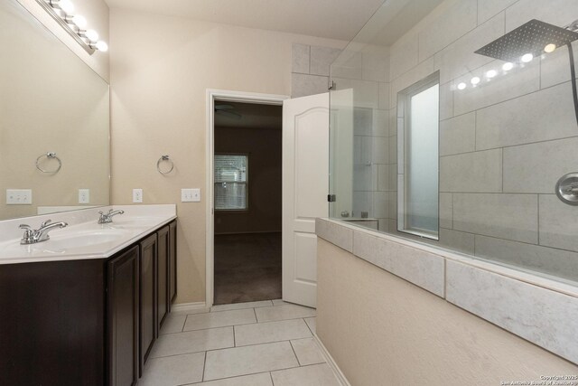 1843 Gray Fox, San Antonio, TX 78245 - full bath featuring double vanity, baseboards, tiled shower, tile patterned floors, and a sink