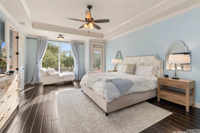 bedroom featuring visible vents, ornamental molding, dark wood-style flooring, baseboards, and a tray ceiling