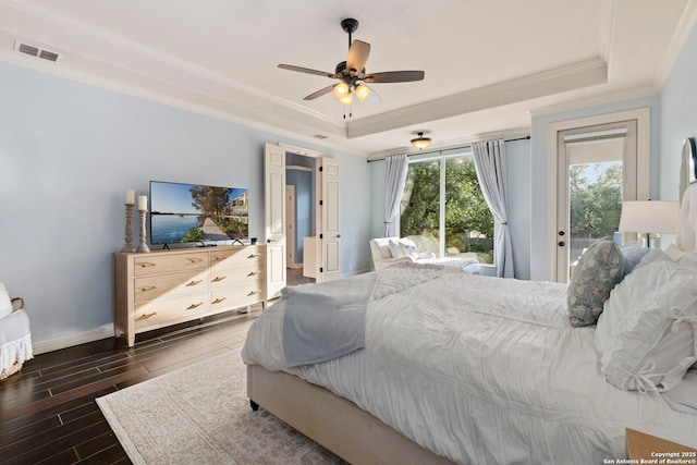 bedroom with access to outside, wood finished floors, a raised ceiling, baseboards, and ornamental molding
