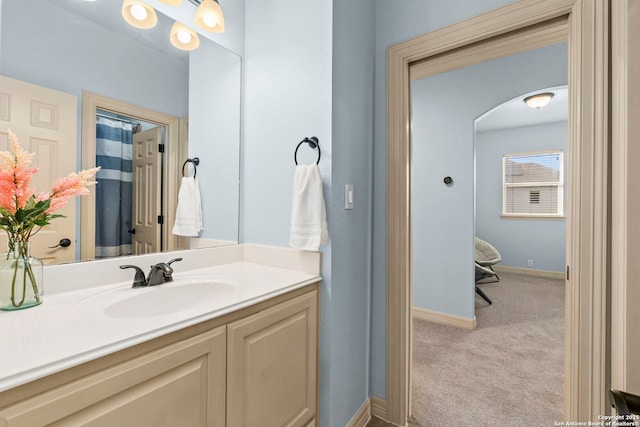 bathroom with vanity and baseboards