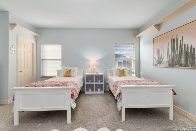 bedroom featuring baseboards and light carpet