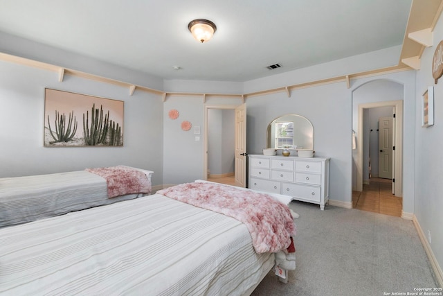 bedroom with light colored carpet and visible vents