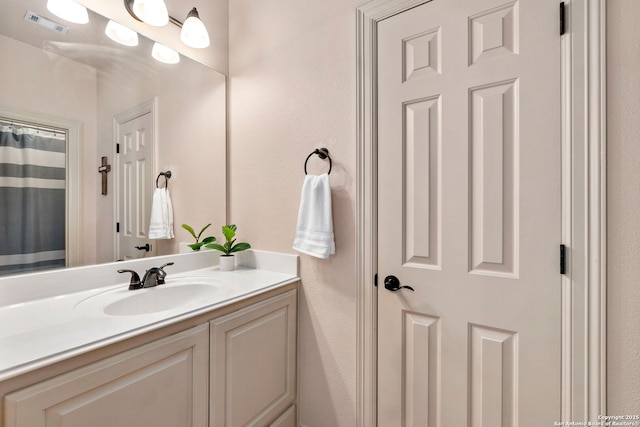 bathroom featuring visible vents and vanity