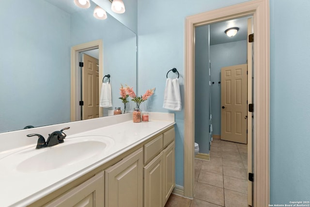 bathroom featuring vanity, tile patterned floors, and toilet