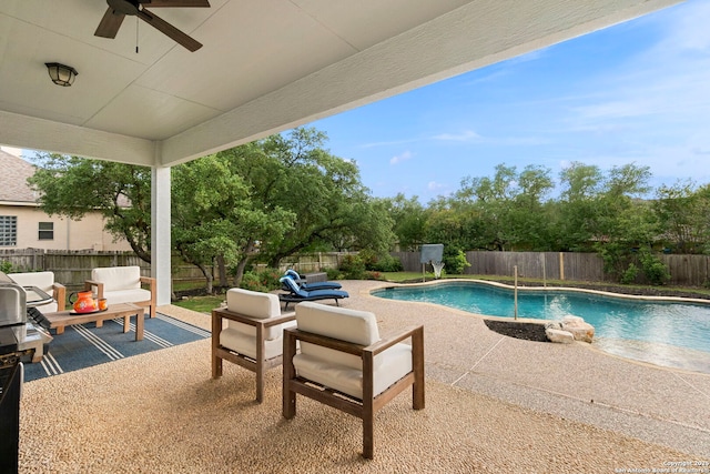 view of swimming pool featuring a patio, a fenced backyard, a ceiling fan, and a fenced in pool