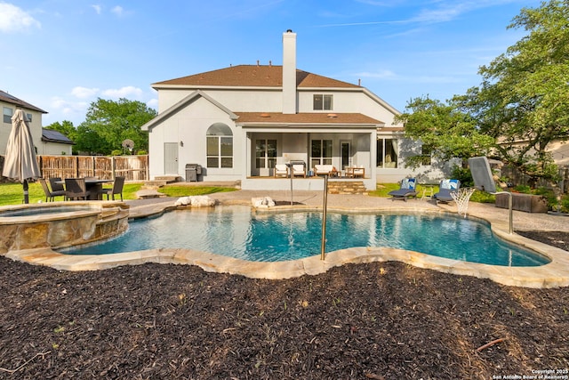back of property with roof with shingles, a patio area, stucco siding, and fence