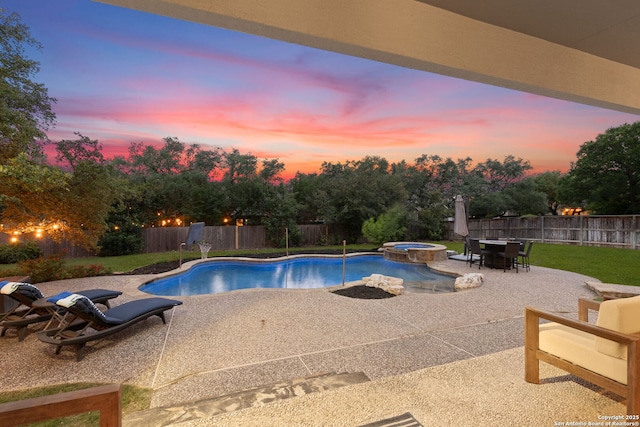 view of swimming pool with a fenced backyard, a patio, and a pool with connected hot tub