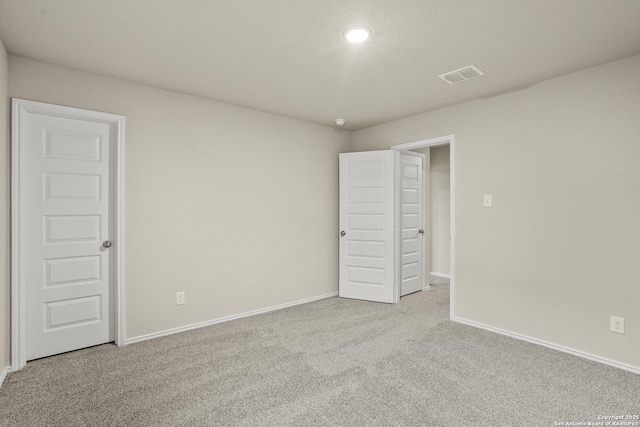 unfurnished bedroom featuring baseboards, carpet flooring, recessed lighting, and visible vents