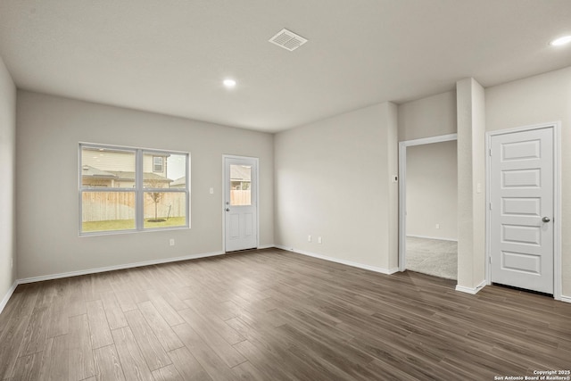 unfurnished living room with recessed lighting, baseboards, visible vents, and dark wood-style floors