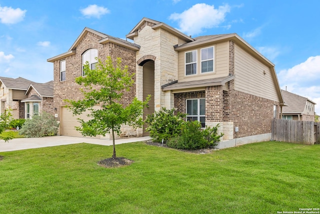 traditional-style house with brick siding, fence, a front lawn, concrete driveway, and an attached garage