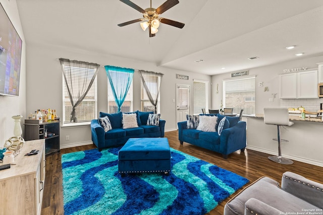 living area with ceiling fan, recessed lighting, baseboards, lofted ceiling, and dark wood-style floors