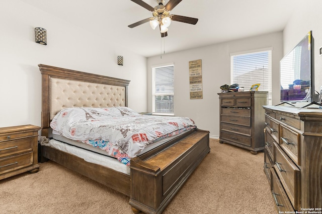 bedroom with light colored carpet and a ceiling fan