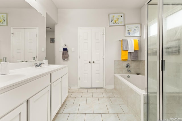 bathroom featuring a sink, tile patterned flooring, double vanity, a shower stall, and a bath